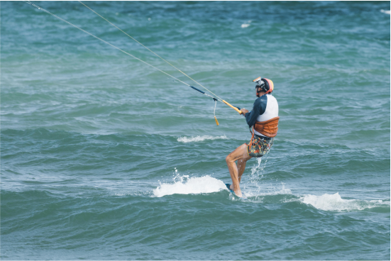 Kitesurfing lesson 3. Guy with orange helmet kitesurfing in Fuerteventura