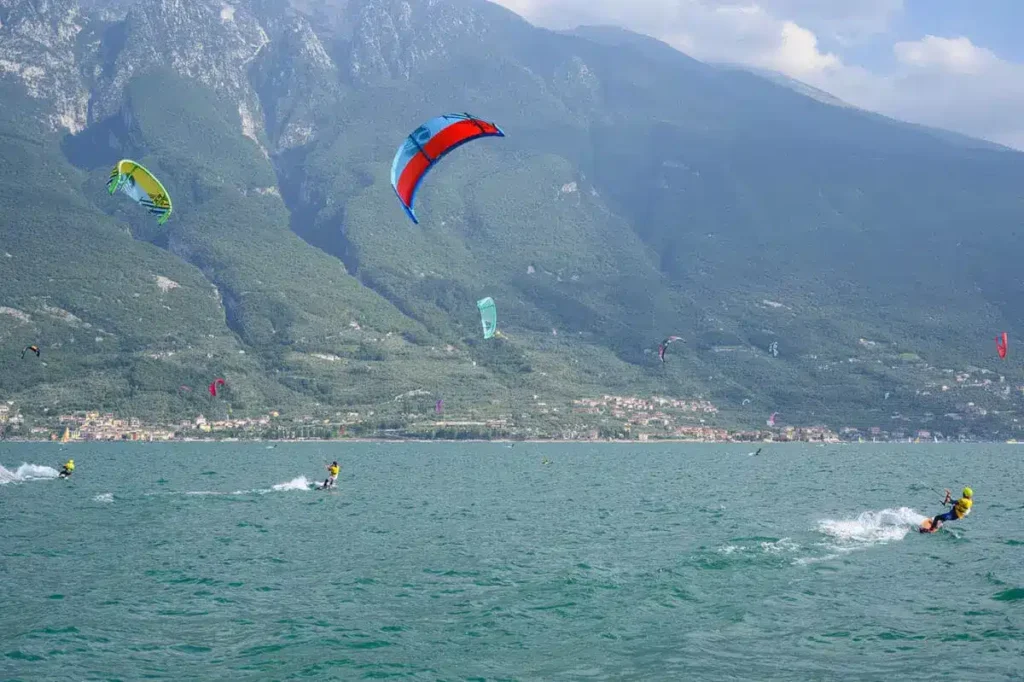 Kitesurfing Lake Garda, Italy, Mountains in the background and multiple kitesurfers in action