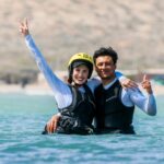 Instructor smiling together with a beginner kiter in the water