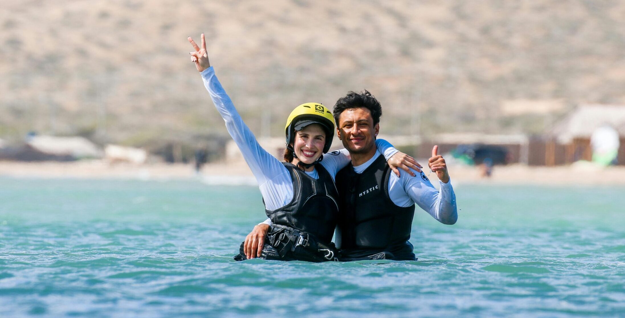 Instructor smiling together with a beginner kiter in the water