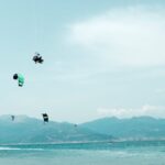 Windsurf and kitesurf coexisting together in the water. A multitude of kiter and windsurfers