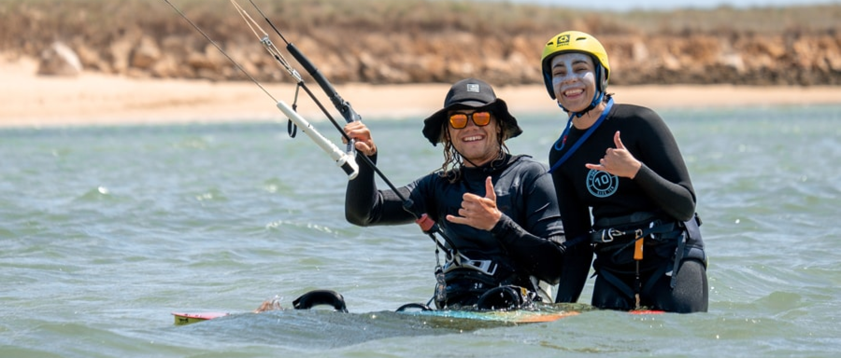 Kitesurfing lessons, kite instructor and student smiling