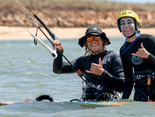 Kitesurfing lessons, kite instructor and student smiling