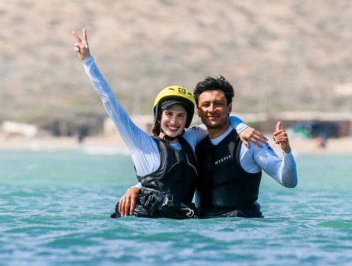 Instructor smiling together with a beginner kiter in the water